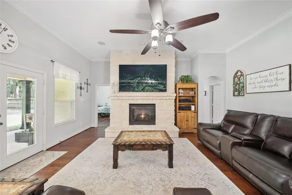 a living room with furniture a flat screen tv and a fireplace