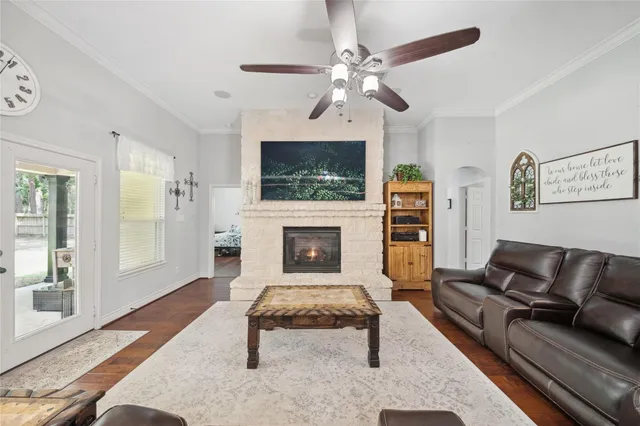 a living room with furniture a flat screen tv and a fireplace
