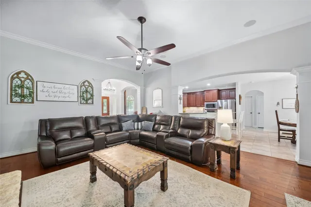 a living room with furniture a couch and wooden floor