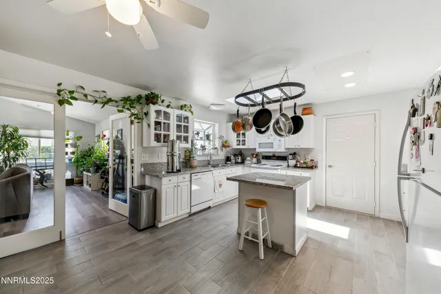 a kitchen with a refrigerator and white cabinets