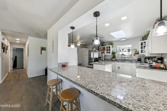 a kitchen with stainless steel appliances granite countertop a sink counter space and wooden floor