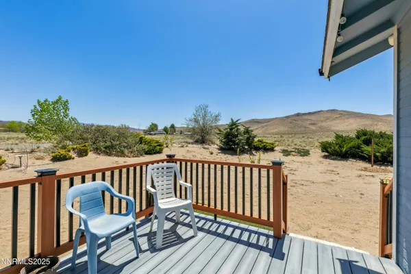 a view of a balcony with wooden floor and outdoor seating