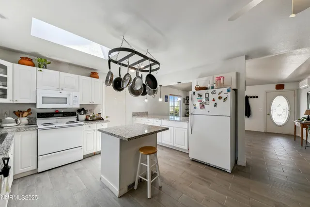 a kitchen with white cabinets and refrigerator