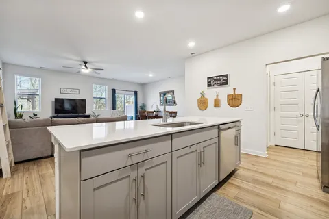 a kitchen with stainless steel appliances granite countertop a sink and a stove