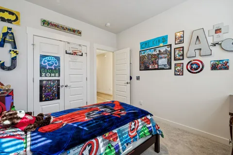 a bedroom with a bed and a tv on the dresser