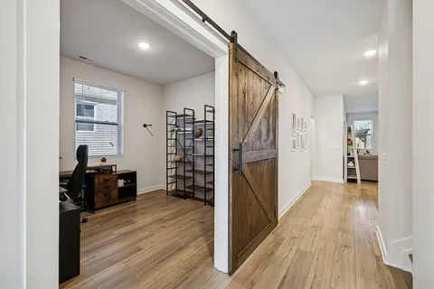 a view of a workspace with furniture and wooden floor