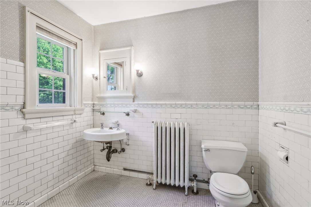 2329 Stillman Road Cleveland, OH 44118 - Photo 31 of 49 Beautiful original bathroom with subway tile walls and hex tile flooring, radiator heating unit, and toilet