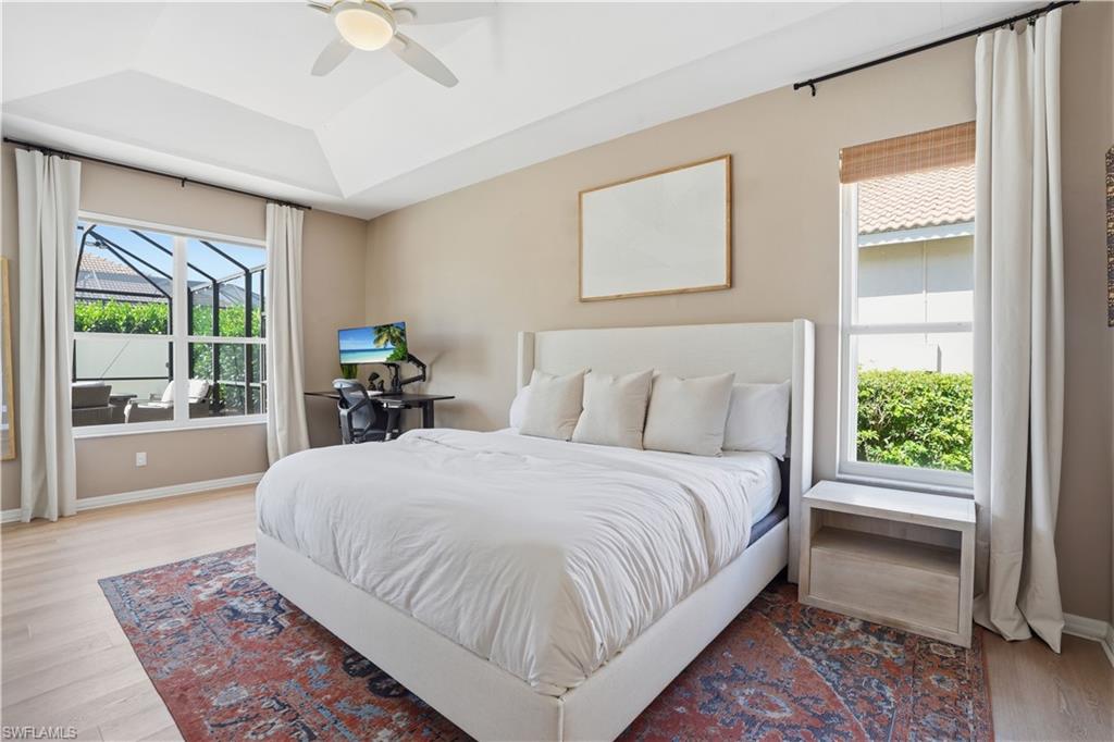 4356 Mistlethrush Lane Naples, FL 34119 - Photo 13 of 38 a bedroom with a large bed and a window