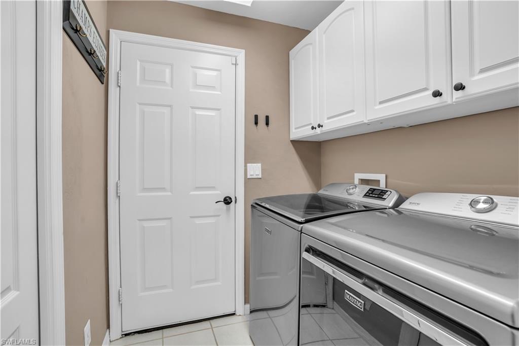 4356 Mistlethrush Lane Naples, FL 34119 - Photo 23 of 38 a utility room with dryer and washer