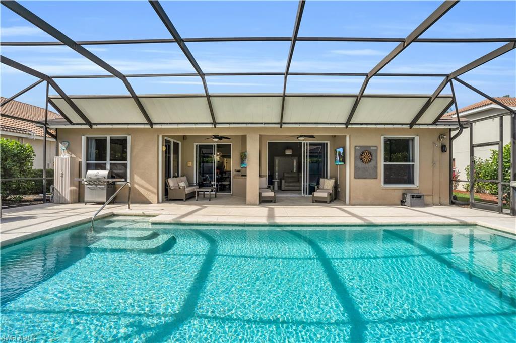 4356 Mistlethrush Lane Naples, FL 34119 - Photo 26 of 38 a view of a house with sitting area and swimming pool