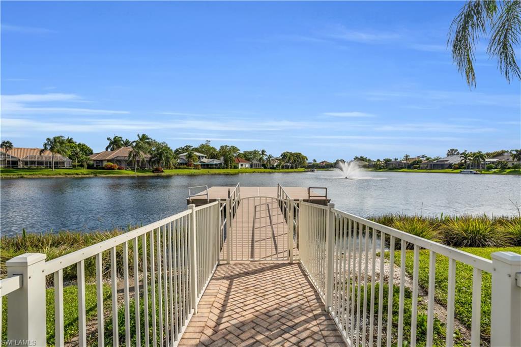 4356 Mistlethrush Lane Naples, FL 34119 - Photo 37 of 38 a view of a lake with a city skyline in the background