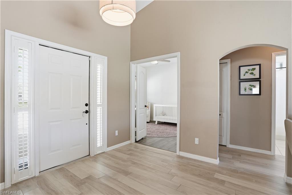 4356 Mistlethrush Lane Naples, FL 34119 - Photo 4 of 38 a view of a room with wooden floor and bathroom view