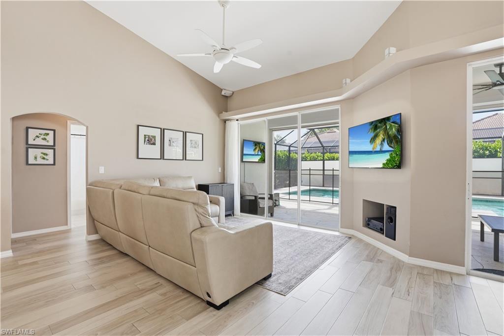 4356 Mistlethrush Lane Naples, FL 34119 - Photo 6 of 38 a living room with furniture fireplace and flat screen tv
