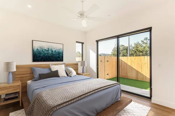 a bedroom with a large window and a bed