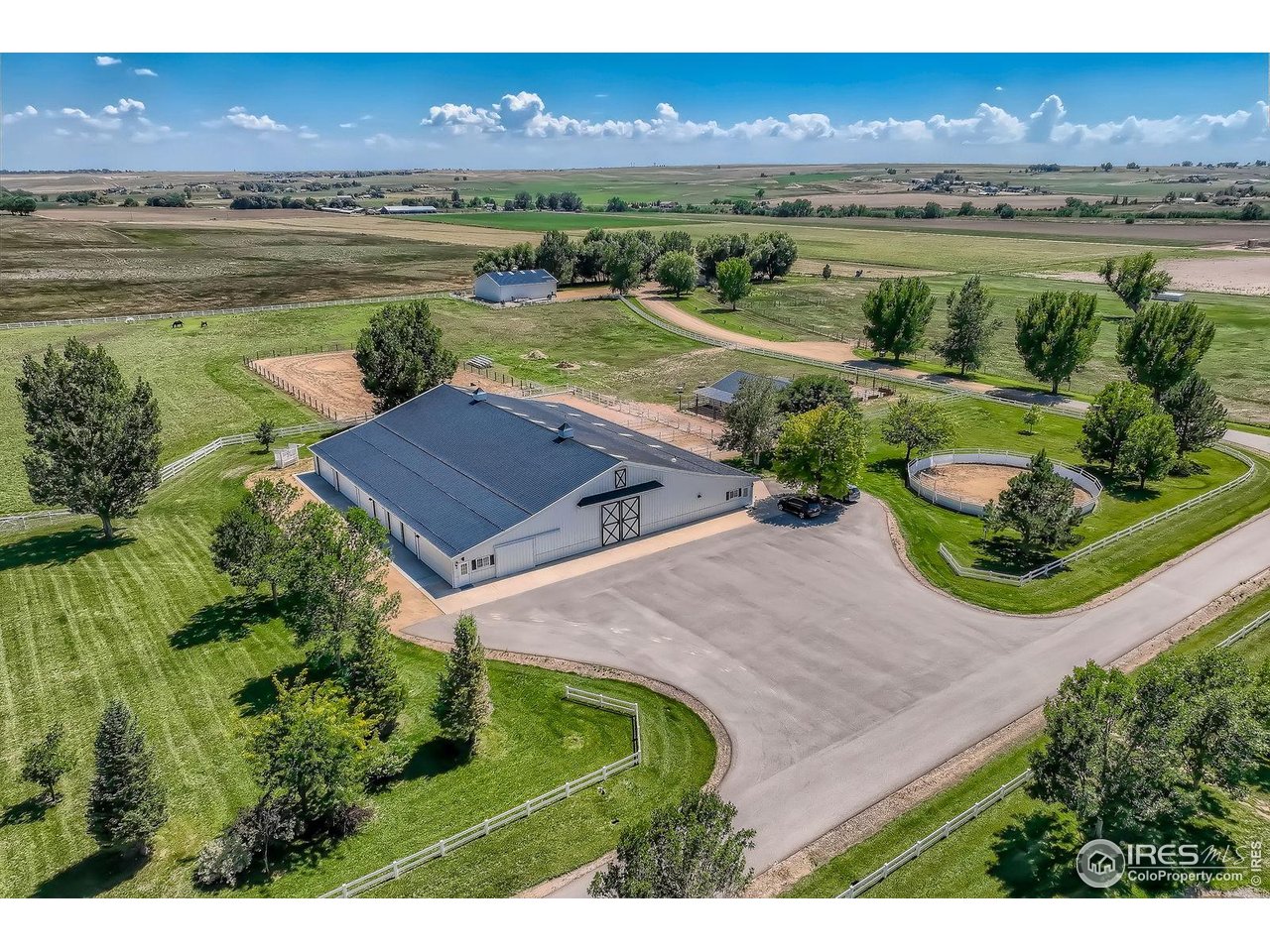 an aerial view of a house with a garden and lake view