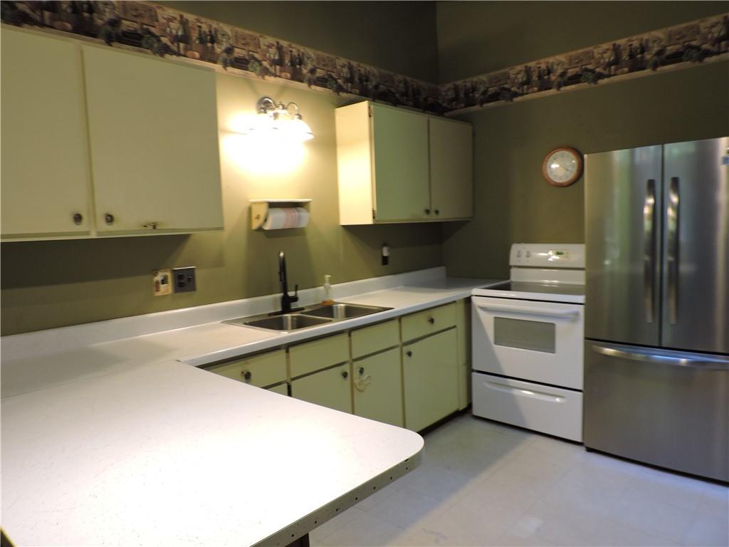 155 Maple Road Acme, PA 15610 - Photo 13 of 39 a kitchen with white cabinets and white appliances