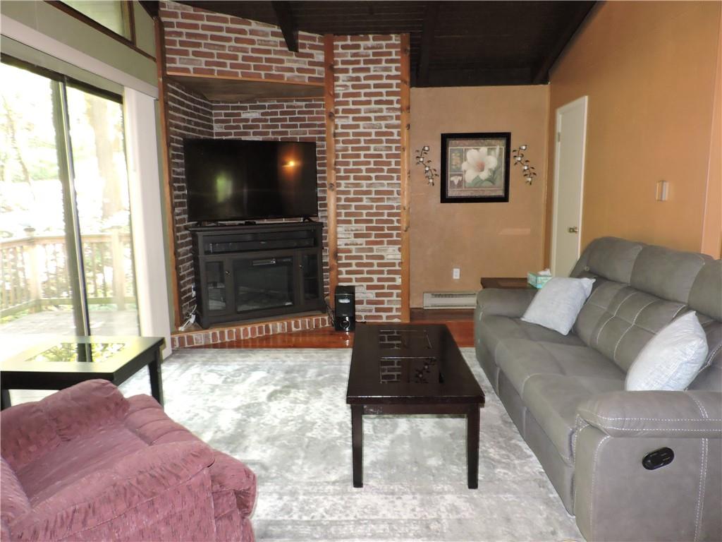155 Maple Road Acme, PA 15610 - Photo 3 of 39 a living room with furniture and a flat screen tv