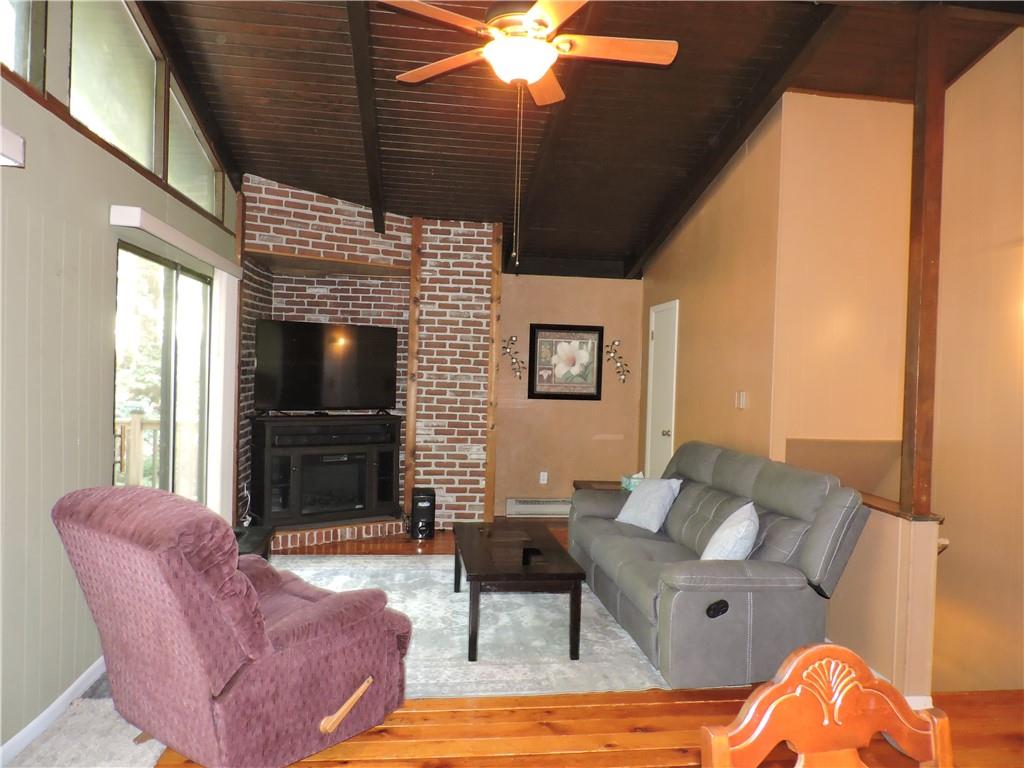 155 Maple Road Acme, PA 15610 - Photo 4 of 39 a living room with furniture a flat screen tv and a fireplace