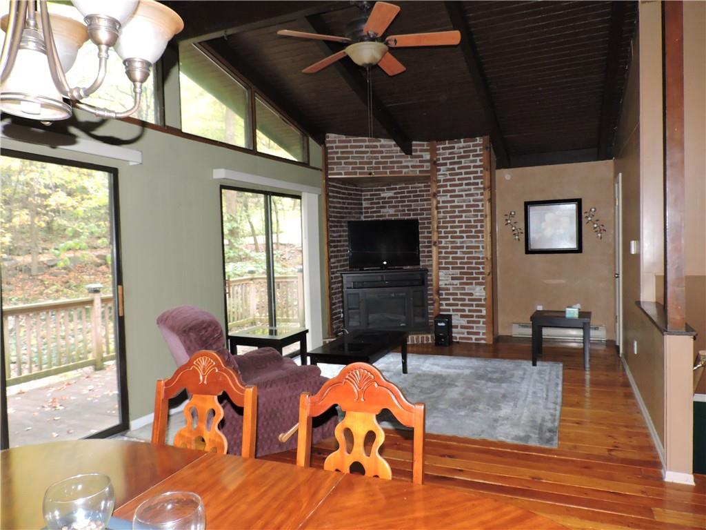 155 Maple Road Acme, PA 15610 - Photo 7 of 39 a living room with furniture flat screen tv and a fireplace