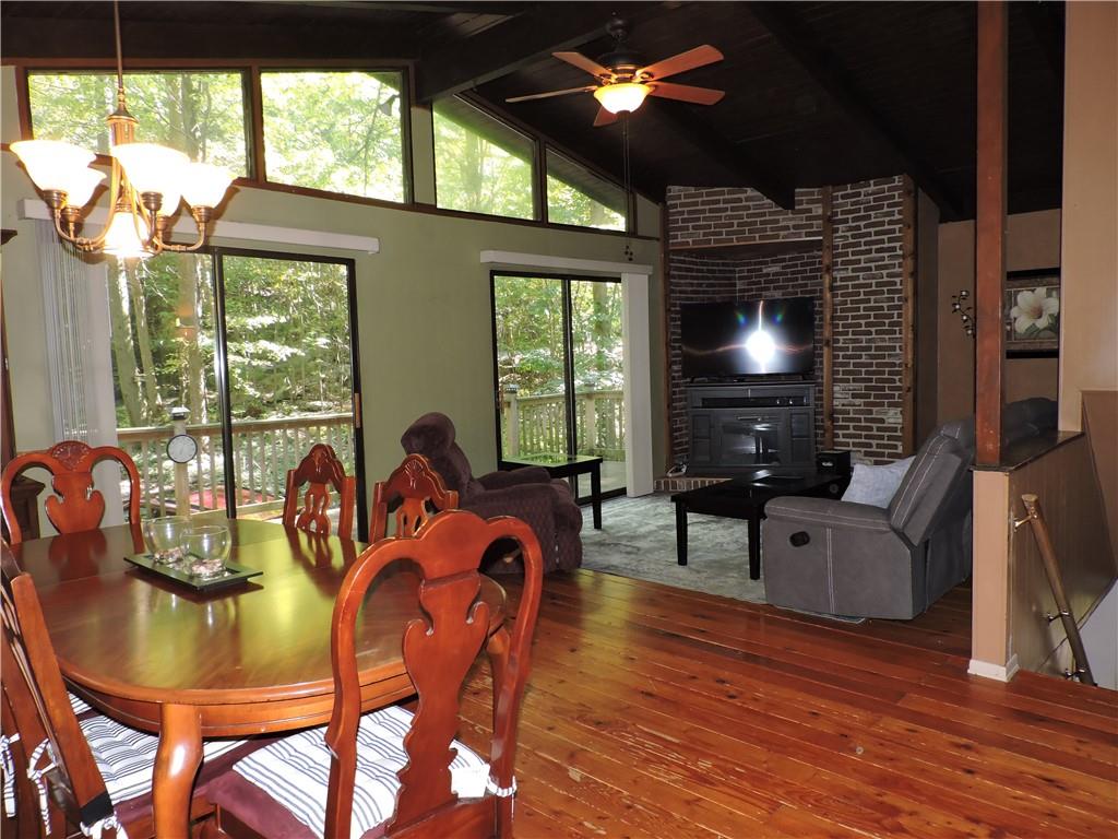 155 Maple Road Acme, PA 15610 - Photo 9 of 39 a dining room with furniture a flat screen tv and a large window