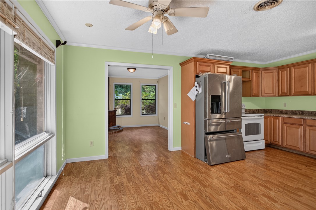 123 Robin Road Westminster, SC 29693 - Photo 22 of 50 A well-lit kitchen with wood cabinetry and modern appliances provides a practical culinary space.