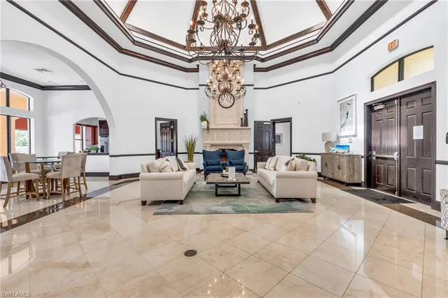 a living room with fireplace furniture and a chandelier