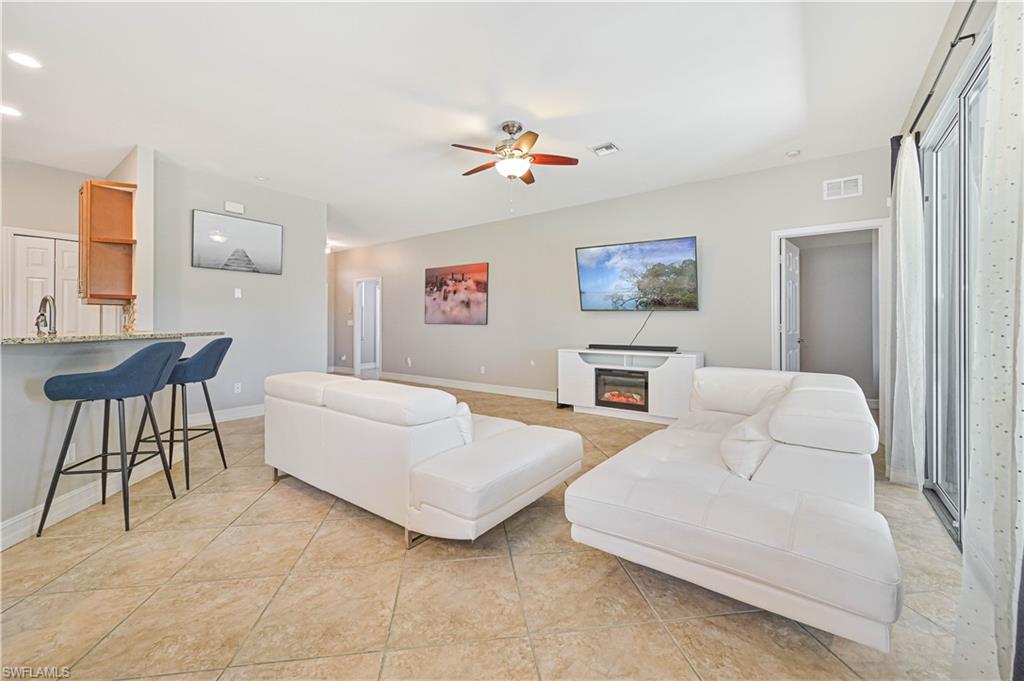238 Stanhope Circle Naples, FL 34104 - Photo 11 of 33 a living room with furniture and a large mirror