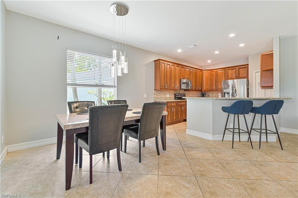 238 Stanhope Circle Naples, FL 34104 - Photo 13 of 33 a view of a dining room with furniture