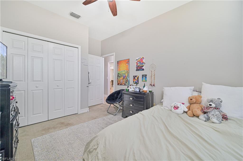 238 Stanhope Circle Naples, FL 34104 - Photo 30 of 33 a bedroom with a bed and wooden floor