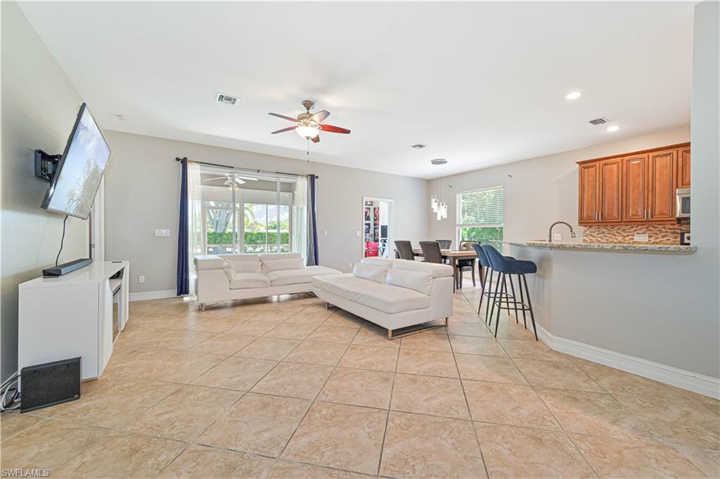 238 Stanhope Circle Naples, FL 34104 - Photo 10 of 33 a living room with furniture and a flat screen tv