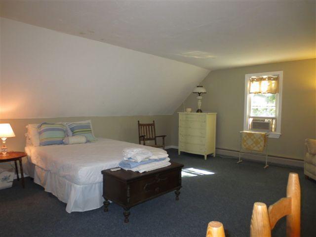 502 Skunknet Road Centerville, MA 02632 - Photo 15 of 24 a bed sitting in a bedroom next to a window