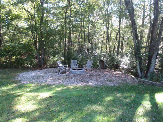 502 Skunknet Road Centerville, MA 02632 - Photo 18 of 24 a view of yard with green space and trampoline