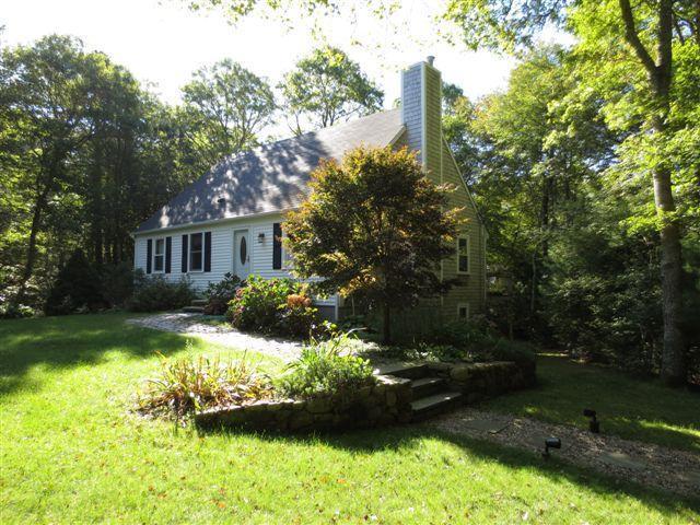 502 Skunknet Road Centerville, MA 02632 - Photo 2 of 24 a front view of a house with a yard and pathway