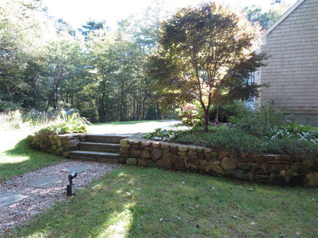 502 Skunknet Road Centerville, MA 02632 - Photo 22 of 24 a view of a backyard with a bench