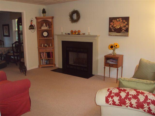 502 Skunknet Road Centerville, MA 02632 - Photo 4 of 24 a living room with furniture and a fireplace