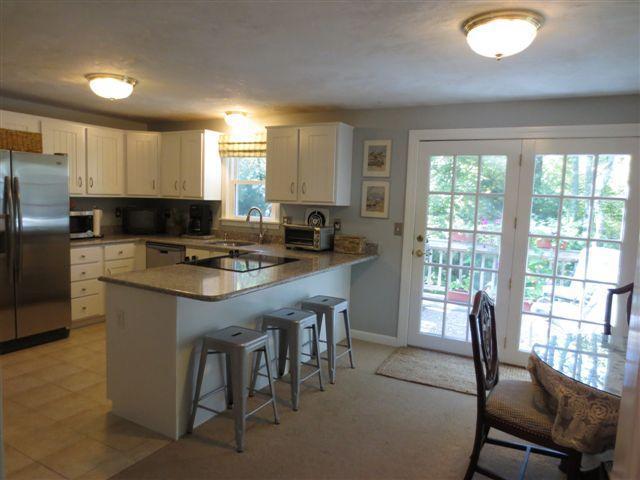 502 Skunknet Road Centerville, MA 02632 - Photo 5 of 24 a kitchen with granite countertop a sink stove and refrigerator