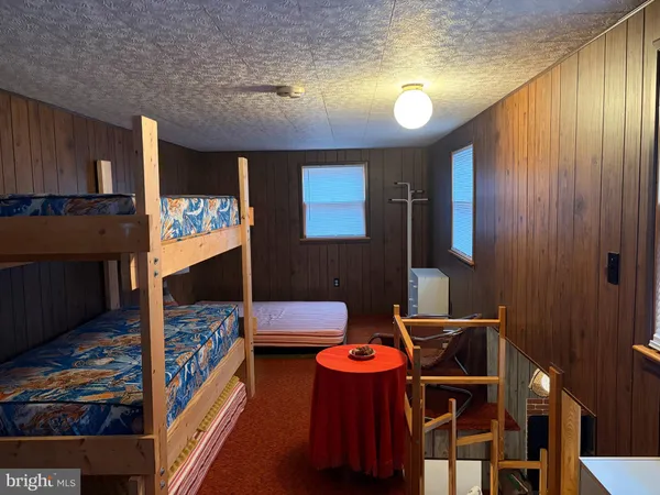 a blue bed sitting in a room next to a window