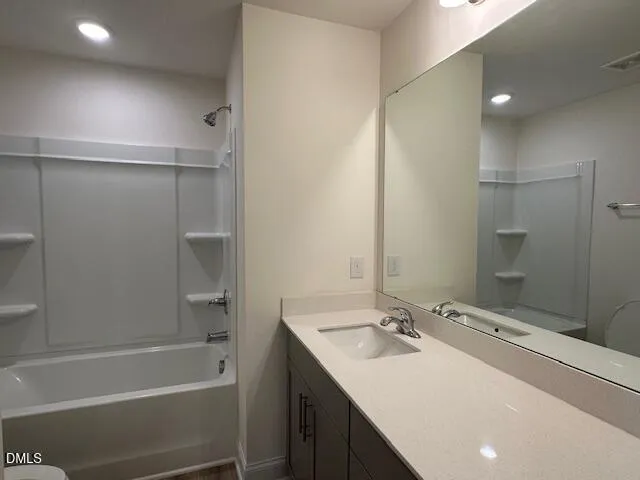 a bathroom with a sink double vanity mirror and a bathtub