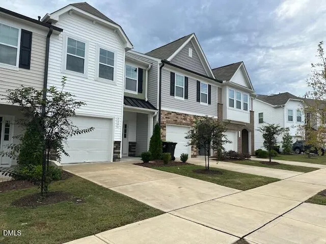 a front view of a building with a garden