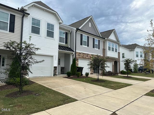 739 Rdg Clf Lane Zebulon, NC 27597 - Photo 2 of 22 a front view of a building with a garden