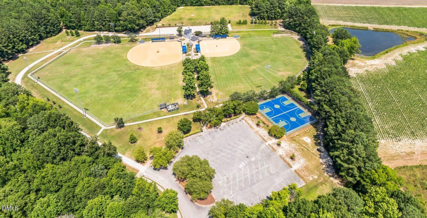 739 Rdg Clf Lane Zebulon, NC 27597 - Photo 21 of 22 an aerial view of a swimming pool with a yard and lake view