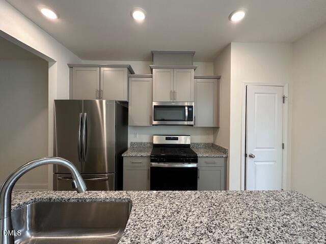 739 Rdg Clf Lane Zebulon, NC 27597 - Photo 6 of 22 a kitchen with stainless steel appliances kitchen island a refrigerator sink and cabinets
