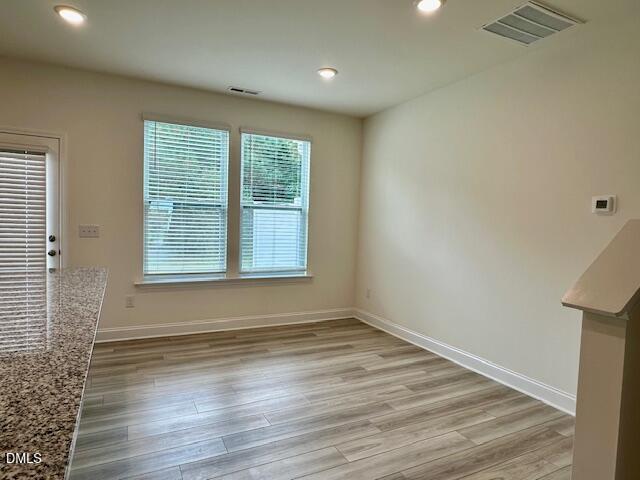 739 Rdg Clf Lane Zebulon, NC 27597 - Photo 8 of 22 a view of an empty room with wooden floor and a window