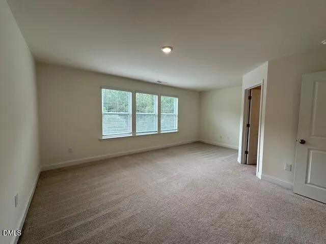 an empty room with a empty space and windows