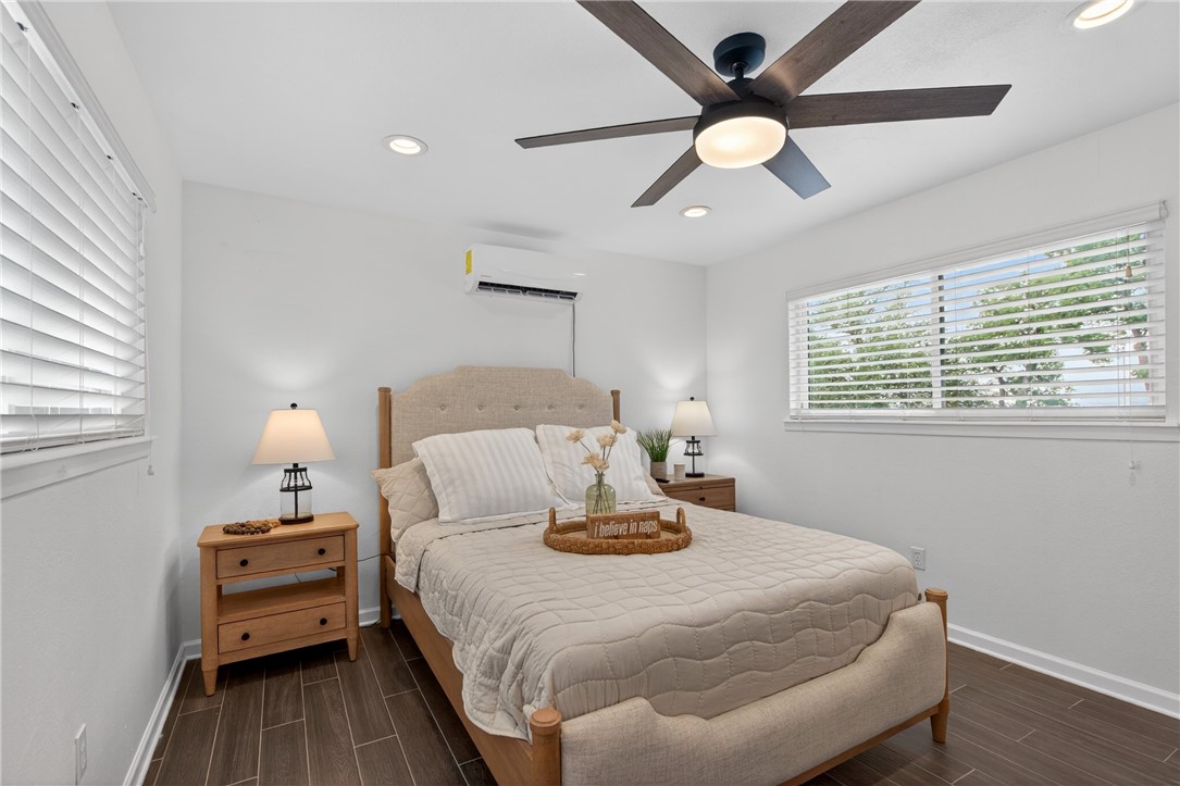 24937 County Road 350 Mathis, TX 78368 - Photo 21 of 39 a bedroom with a bed and a chandelier