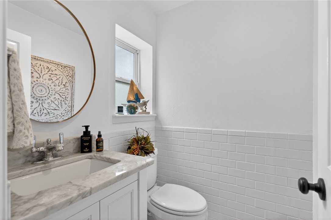 24937 County Road 350 Mathis, TX 78368 - Photo 26 of 39 a bathroom with a toilet a sink and a mirror