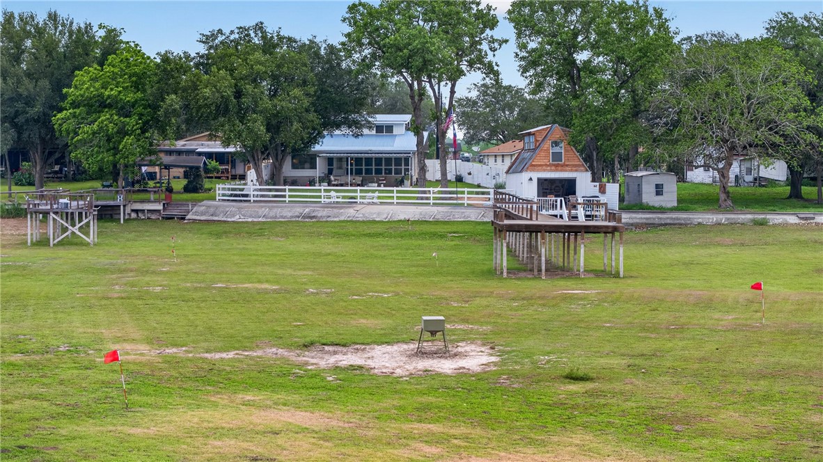 24937 County Road 350 Mathis, TX 78368 - Photo 37 of 39 a view of a swimming pool with lawn chairs with plants and trees