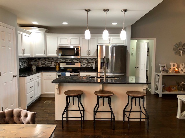 204 Goshen Road Lebanon, TN 37087 - Photo 4 of 24 a kitchen with stainless steel appliances granite countertop a stove a sink a microwave a center island and furniture