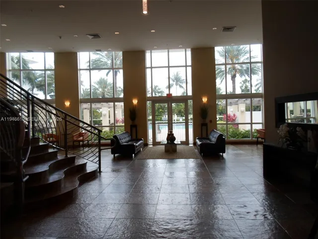 a lobby with furniture and floor to ceiling window