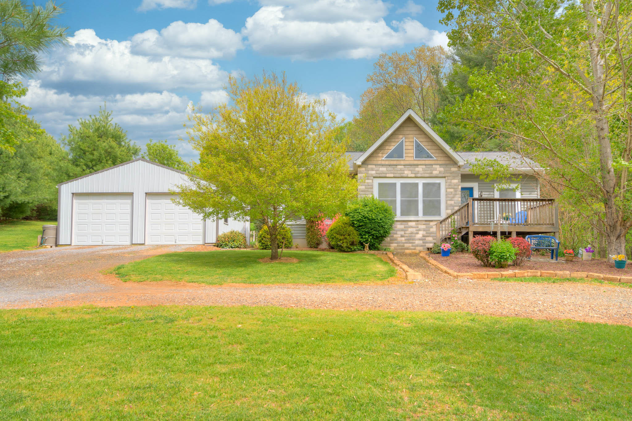 355 Sam Reed Road Northwest Floyd, VA 24091 - Photo 1 of 37 a front view of a house with a yard and garage